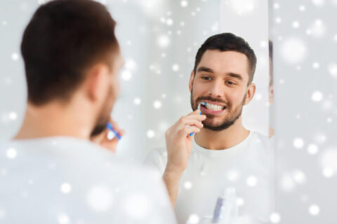 Young man brushing tooth