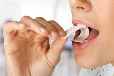 a close-up of a person eating a chewing gum