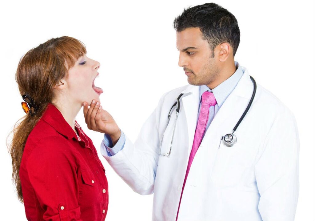 a doctor examining a person's throat