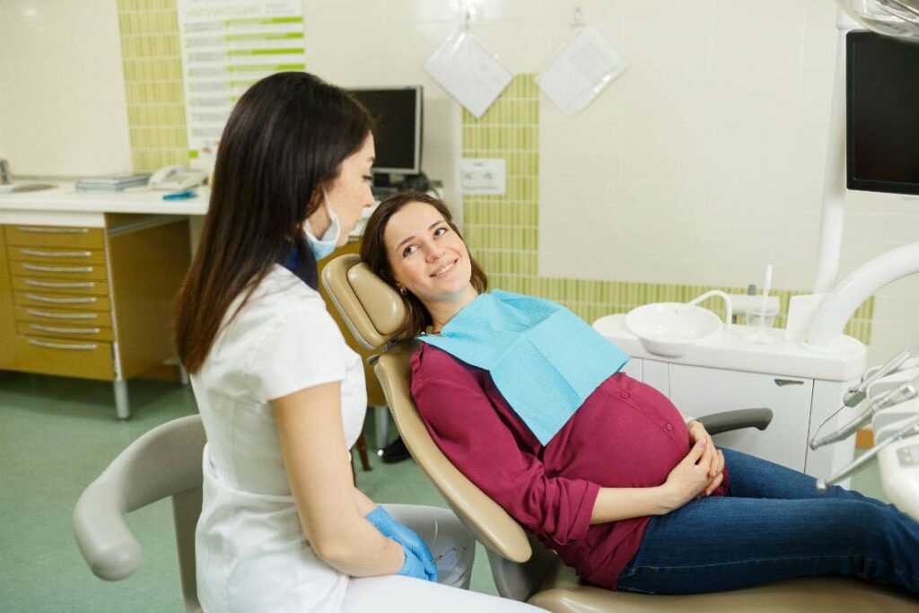 a doctor sitting in a chair with a pregnant person