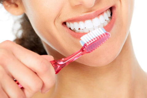 a woman brushing her teeth