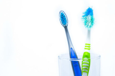 two toothbrushes in a glass